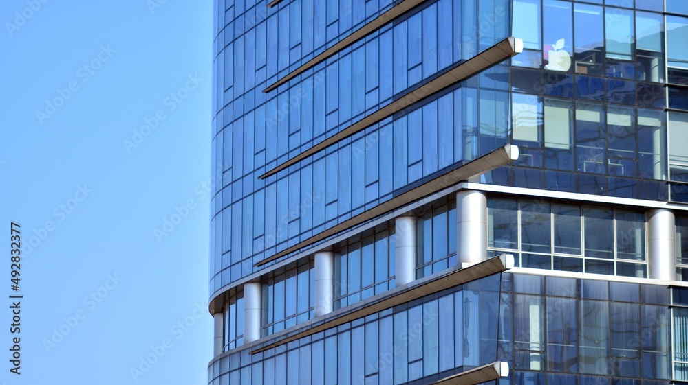 Perspective view to steel and blue glass. Commercial modern city of future. Business concept of successful industrial architecture. The sunlight falling on the building. Perspective view to steel and blue glass. Commercial modern city of future. Business concept of successful industrial architecture. The sunlight falling on the building.