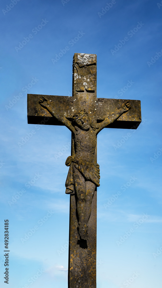 Easter religious background greeting card - Crucifixion of Jesus or crucifix with jesus christ, blue sky - Portrait background