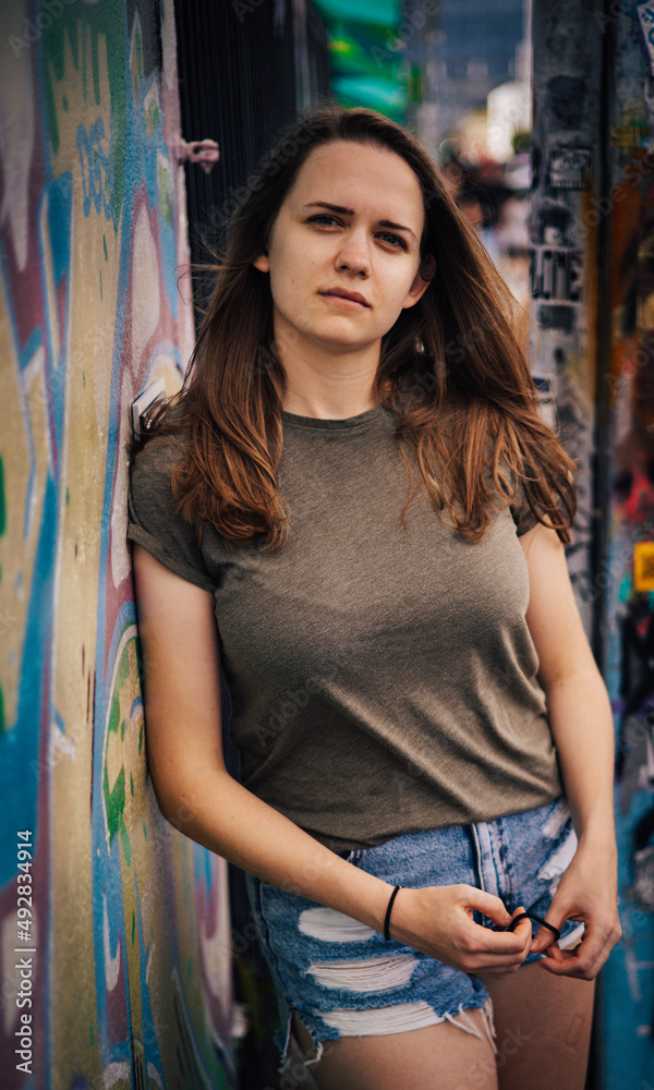 Naklejka premium Street style photo shoot with a young pretty woman in the colorful streets of Miami - travel photography