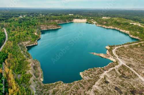 Lake and beach with beautiful blue turquoise water surrounded by green forest. Aerial photography from a drone. Ukraine. concept, vacation, travel, nature and landscape © Volodymyr