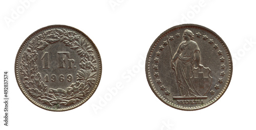 Switzerland - circa 1969: a 1 Franc coin of Switzerland with flowers and twigs around the number. The allegorical female figure Helvetica with spear and shield