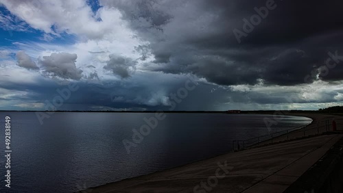 Time lapse shot of grey clouds at sky covering coastline of Latvia and Baltic Sea photo