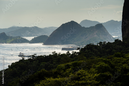 Aerial view of Icaraí and São Francico beach. Immensity of the city of Niterói, Rio de Janeiro, Brazil in the background. Guanabara bay, Eva, Adão and Apple beach in the foreground. Sunny dawn photo