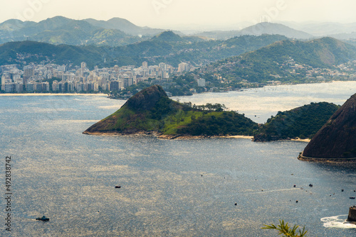 Aerial view of Icaraí and São Francico beach. Immensity of the city of Niterói, Rio de Janeiro, Brazil in the background. Guanabara bay, Eva, Adão and Apple beach in the foreground. Sunny dawn photo