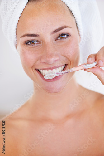 Disciplined brushing equals sparkling teeth. Portrait of a stunning woman brushing her teeth.