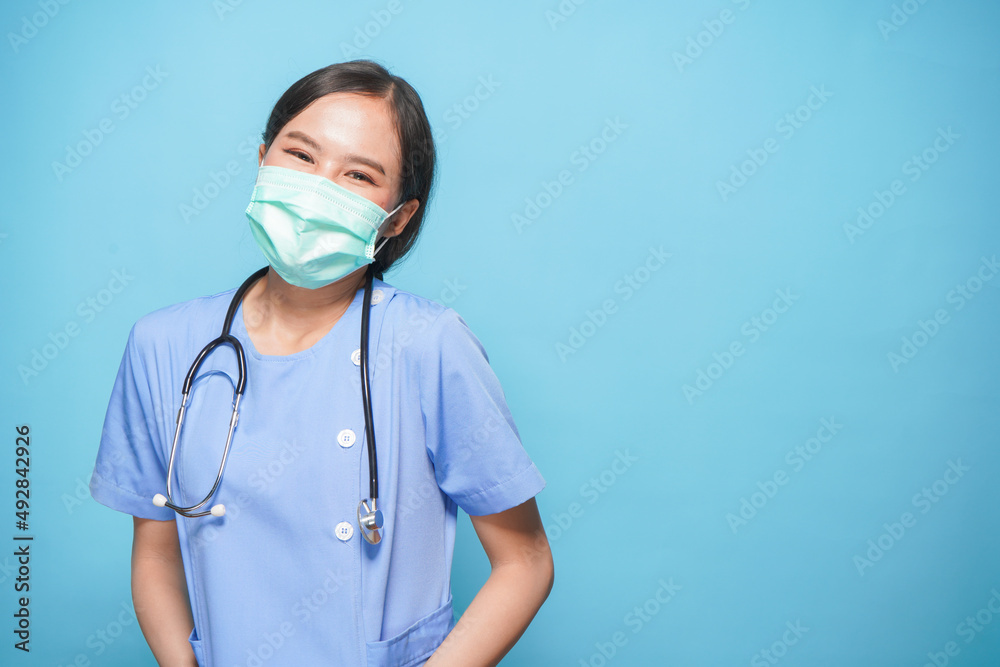 Asian lovely woman doctor or nurse with stethoscope and medical mask with professional and confident ready to treatment patient over blue background portrait Asian lovely woman doctor or nurse with stethoscope and medical mask with professional and confident ready to treatment patient over blue background portrait