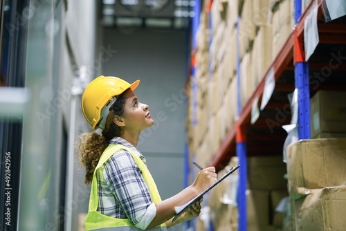 Worker inventory inspect staff checking stock and inspect package box with checklist in warehouse factory storage products shipment distributor logistic supply for counting and management photo