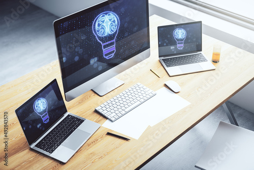 Modern computer monitor with creative light bulb hologram with human brain, idea and brainstorming concept. 3D Rendering