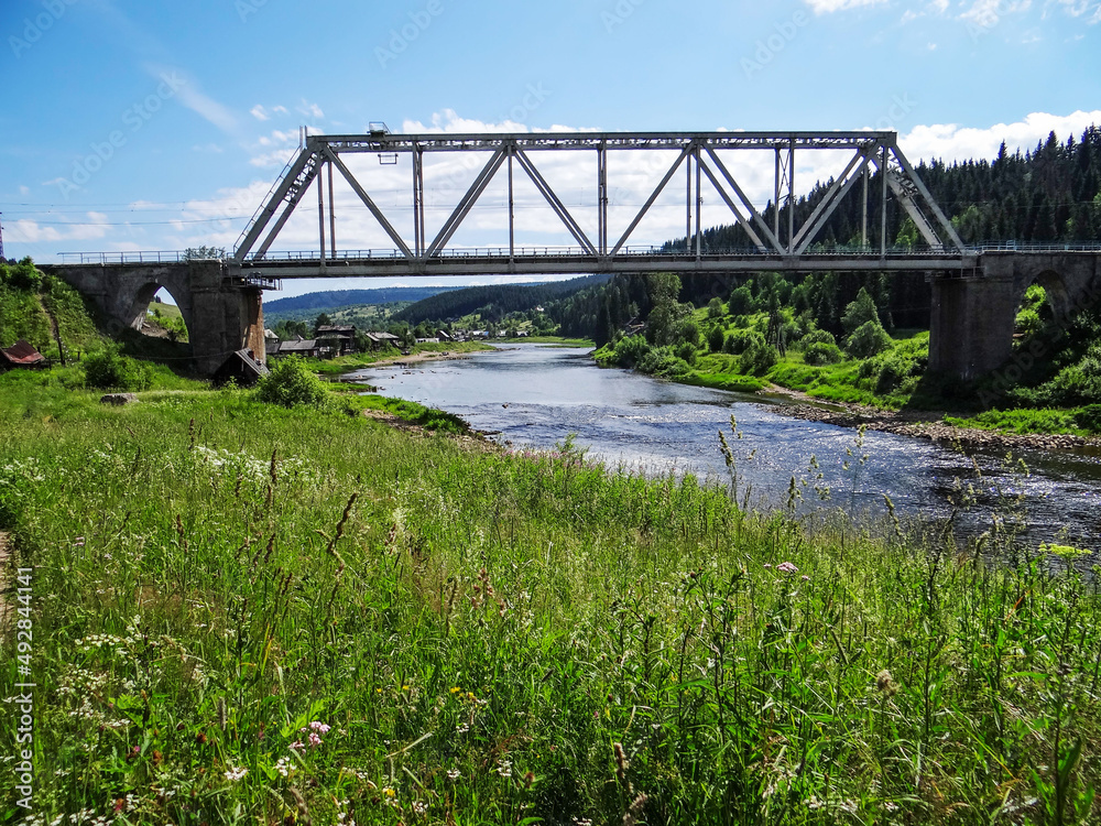 Railway bridge over the river Usva. Usva village. Perm region. Russia Railway bridge over the river Usva. Usva village. Perm region. Russia