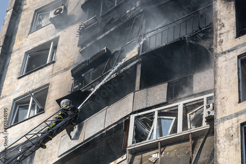 War in Ukraine. Firefighters on damaged residential building in Kyiv