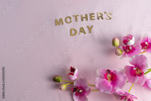 Mother's day with flowers on light pink background photo