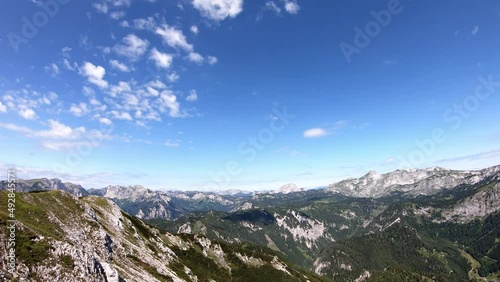 Timelapse of scenic view from Messnerin on Hochtor and alpine mountain chains in Styria, Austria, Hochschwab region. Clouds are moving over the mountain peaks. Summer day. Hiking in Alps, Tragoess
 photo