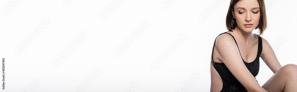 Young pregnant woman in swimsuit posing isolated on white, banner Young pregnant woman in swimsuit posing isolated on white, banner