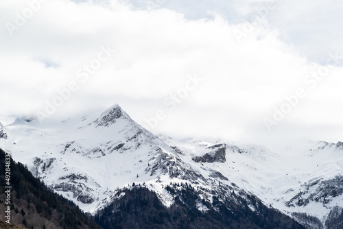 Snowy mountain with white cloudy sky in french Pyrenees. 