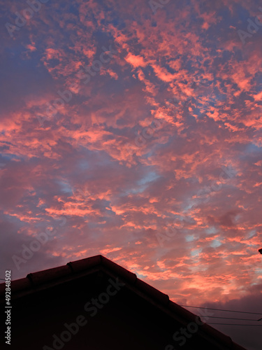 portrait format image of the silhouette of a roof, with a stupendous twilight sky in the background.