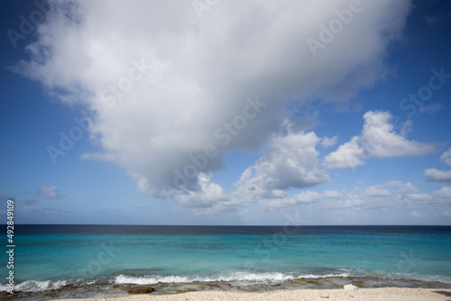 Turquoise sea, blue sky with big cloud. Seascape. © Vitalina