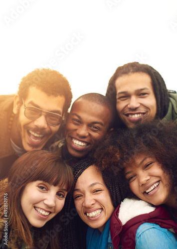 Friends are the family we choose. Portrait of a happy group of friends posing together outside. © Delmaine Donson/peopleimages.com