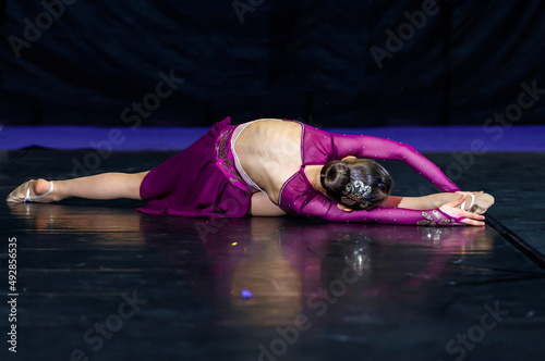 little gymnast lies in a beautiful pose