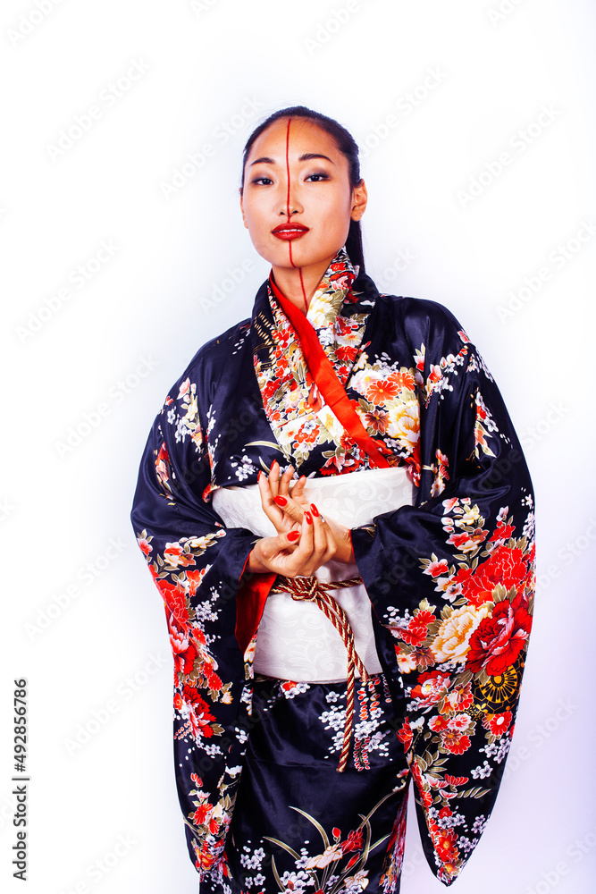 young pretty geisha in black kimono posing isolated on white background, asian ethno young pretty geisha in black kimono posing isolated on white background, asian ethno