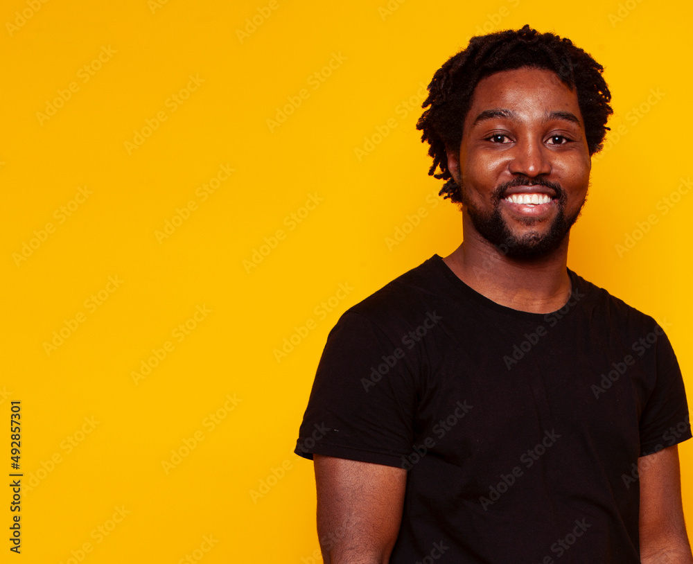 young handsome african american guy student posing cheerful and gesturing on yellow background, lifestyle people concept young handsome african american guy student posing cheerful and gesturing on yellow background, lifestyle people concept