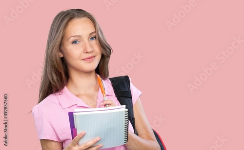 Smiling happy teen student girl hold books