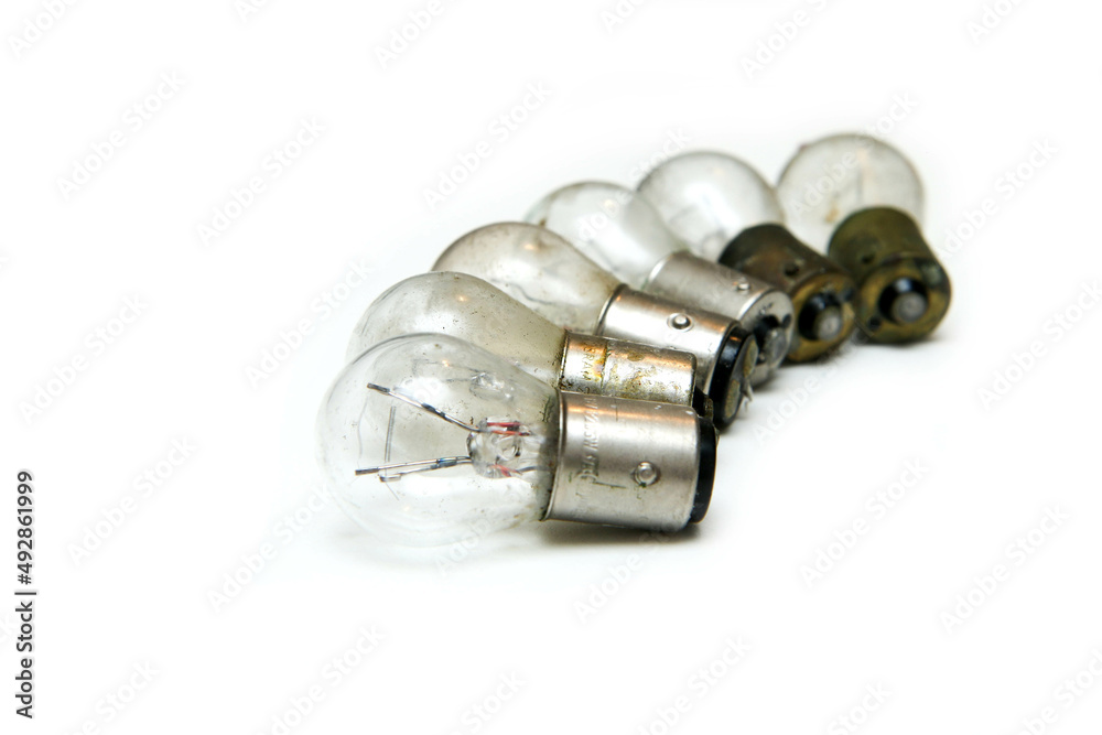The small group of old shabby small bulbs for the car lights isolated in the white background. The small group of old shabby small bulbs for the car lights isolated in the white background.