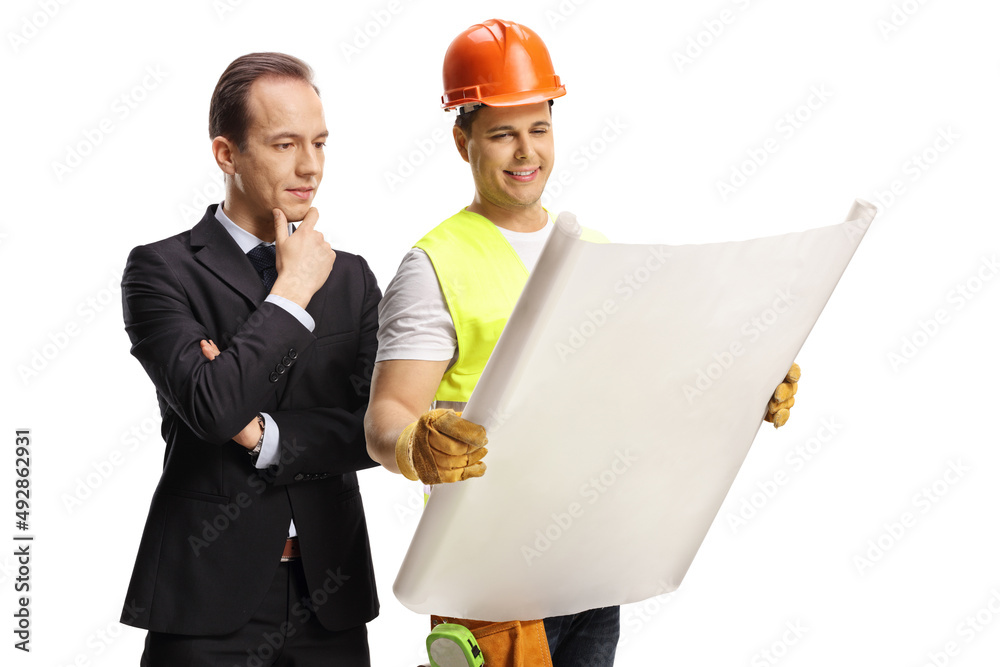 Businessman and a construction site engineer looking at a blueprint Businessman and a construction site engineer looking at a blueprint