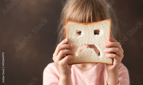 diet celiac gluten free sad bread in the hands of a child. Gluten free concept 
