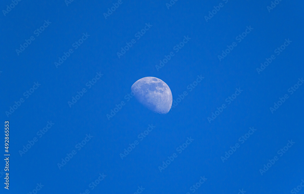 Zunehmender Mond am blauen Himmel, Bayern, Deutschland Zunehmender Mond am blauen Himmel, Bayern, Deutschland