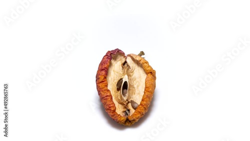Red apple becomes dry and wrinkled. Half cutted fruit dehydrates quickly. Fast timelapse. Concept of aging, time, health, skincare, cosmetic care.