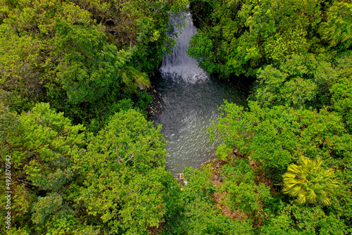 Aerial view of a hidden waterfall found in a forest located in Mauritius 