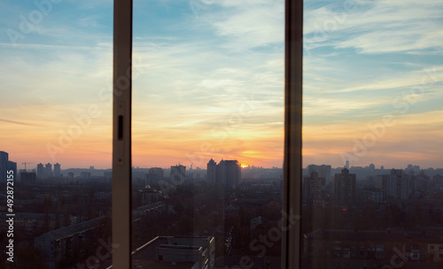 Cityscape of Kyiv at the sunset through the window