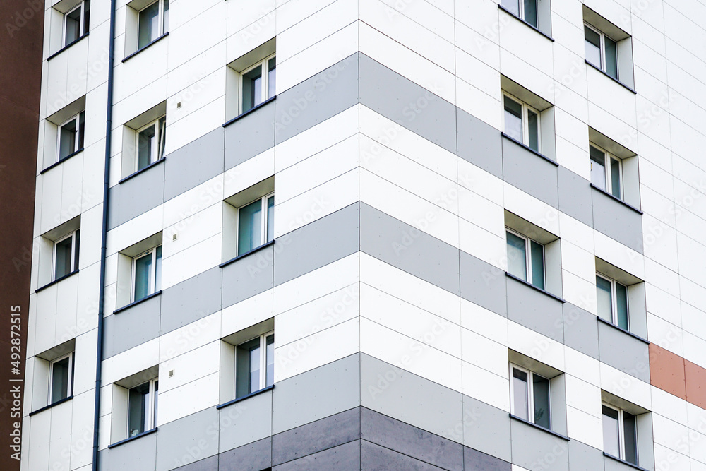 fragment of the facade of a renovated and thermally insulated multi-storey apartment house