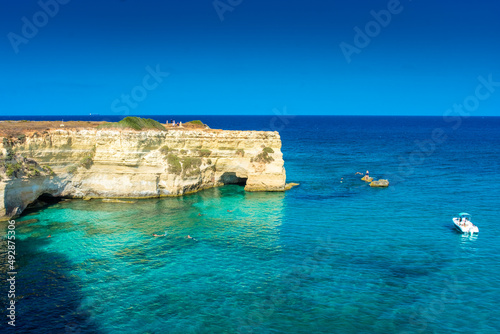 SALENTO, ITALY, 11 AUGUST 2021 The beautiful crystal clear Sea of Apulia from the cliffs and the sea stacks of Sant'Andrea