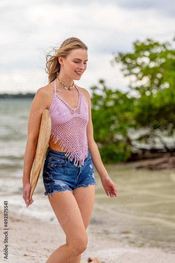 Lovely Blonde Model Enjoying A Summers Day While Preparing To Surf On The Ocean With Her Boogie Board Lovely Blonde Model Enjoying A Summers Day While Preparing To Surf On The Ocean With Her Boogie Board