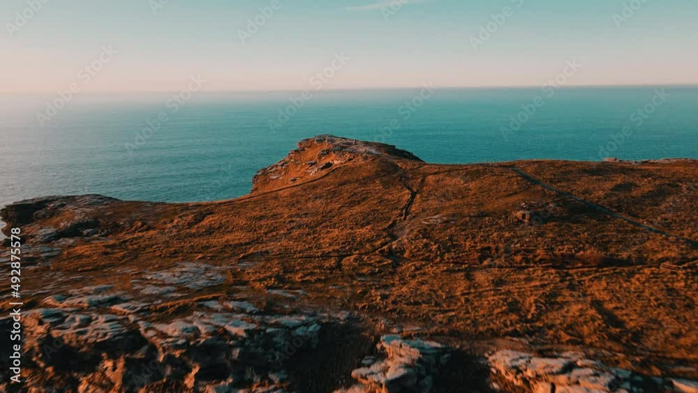 Monument to King Arthur in Britain.Aerial view of a rock on a background of the sea . Monument to King Arthur in Britain.Aerial view of a rock on a background of the sea .