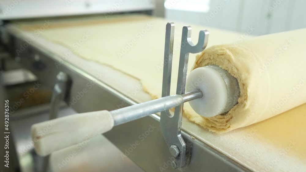 Industrial food factory or bakery.Production of confectionery products. Dough on an automatic conveyor belt, the process of baking cakes at the factory.A confectionery factory or bakery.