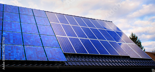 Obraz na plátně different solar modules on a roof panorama