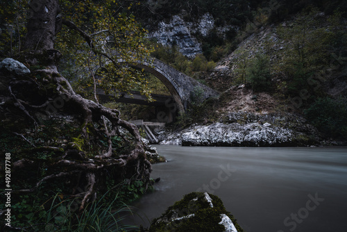 Stone arch bridge over river in Arta city, Greece. photo