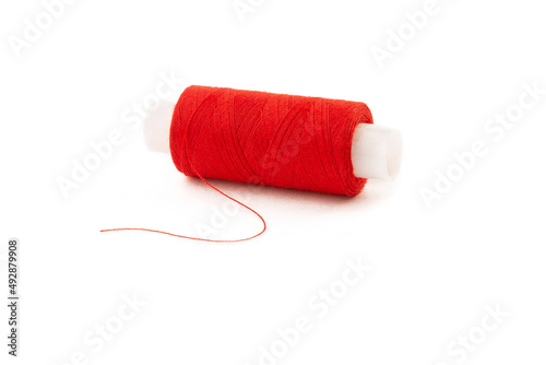Spool of red threads on a white isolated background.