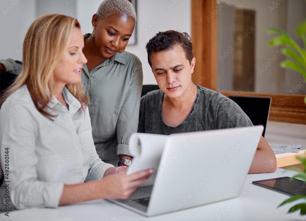 They never lack passion and dedication for work. Shot of a group of businesspeople working together on a laptop in an office. They never lack passion and dedication for work. Shot of a group of businesspeople working together on a laptop in an office.