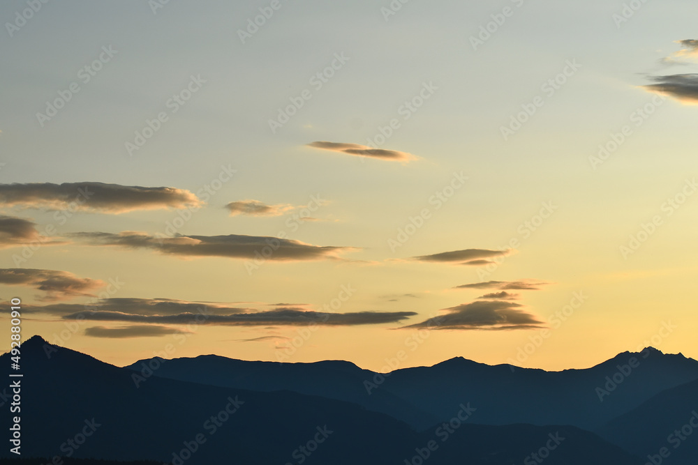 dawn or dusk in the alps with the silhouette of mountains and copy space