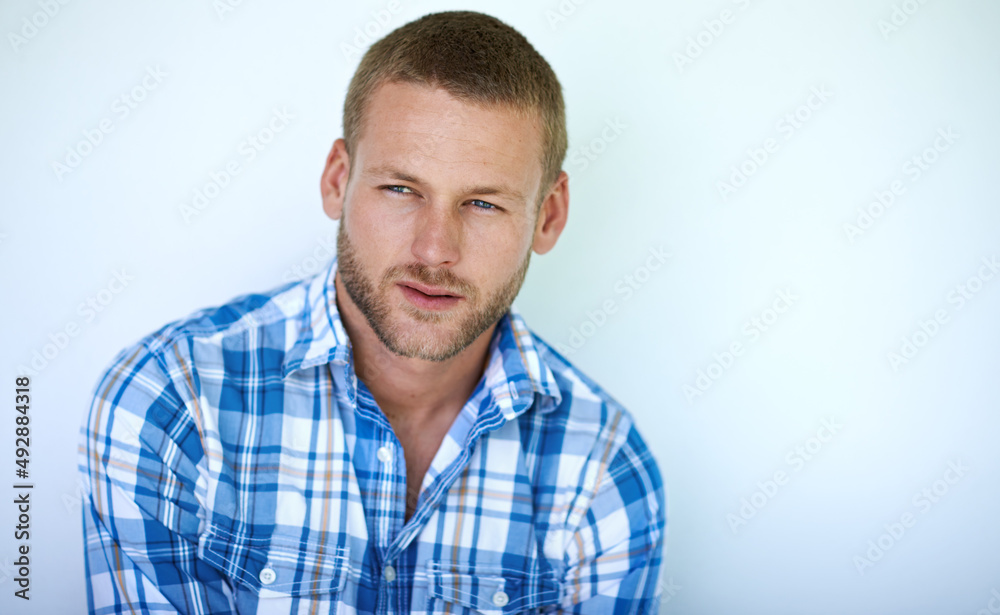 Style is all about your attitude. Studio shot of a handsome young man posing against a white background. Style is all about your attitude. Studio shot of a handsome young man posing against a white background.