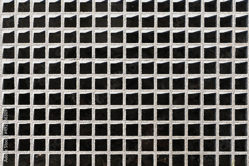 Geometric background. Gray metal grille.