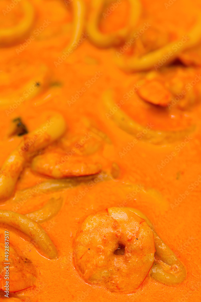 close up shot of shrimp and squid rings in sauce close up shot of shrimp and squid rings in sauce