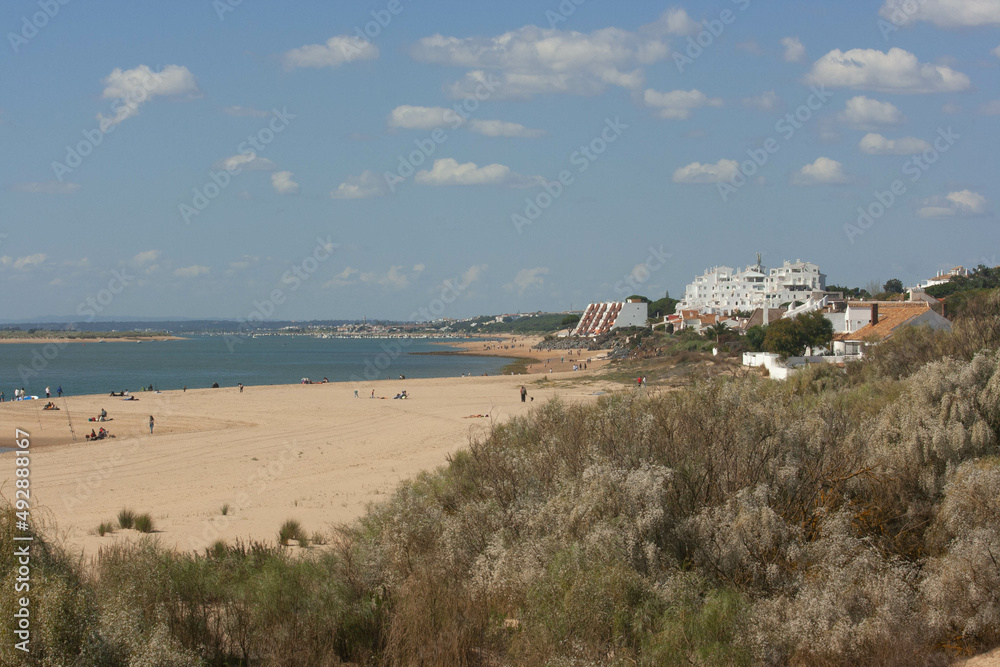 sunny beach day with white dunes and blue sea in huelva spain
