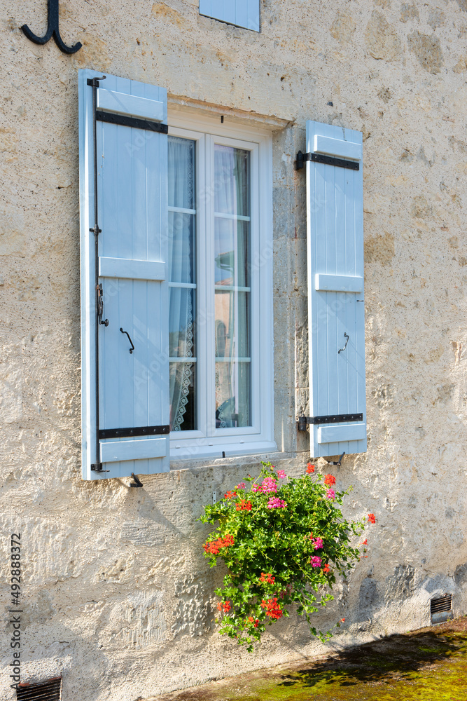 French window with shutters and flowers