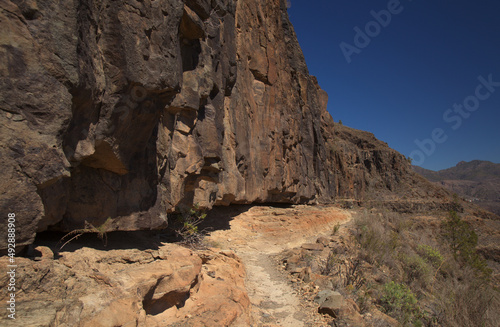 Gran Canaria, landscape of the southern part of the island along Barranco de Arguineguín steep and deep ravine with vertical rock walls, circular hiking route starting at a hamlet Barranquillo Andres 