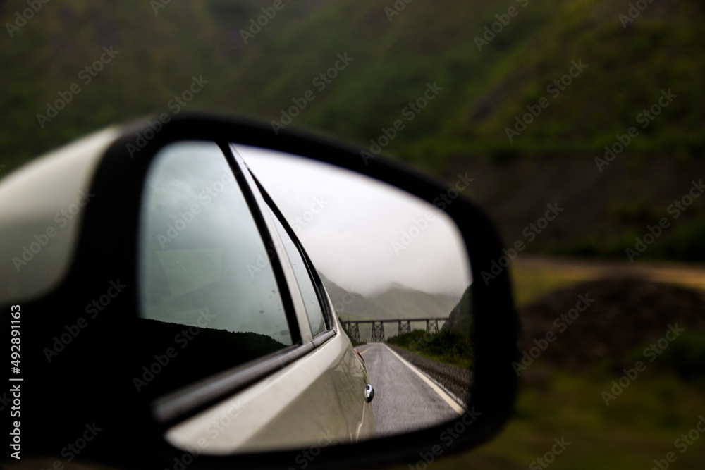 Iron bridge seen through the rearview mirror of a car in Salta, Argentina