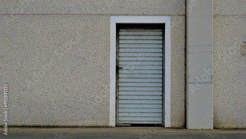 metal pedestrian door on industrial facade